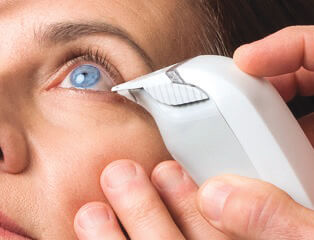 Tear osmolarity device being used in a woman's eye