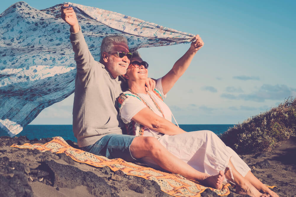 Man and woman senior aged 70 years old. Rest at the beach and enjoy freedom and the good weather.